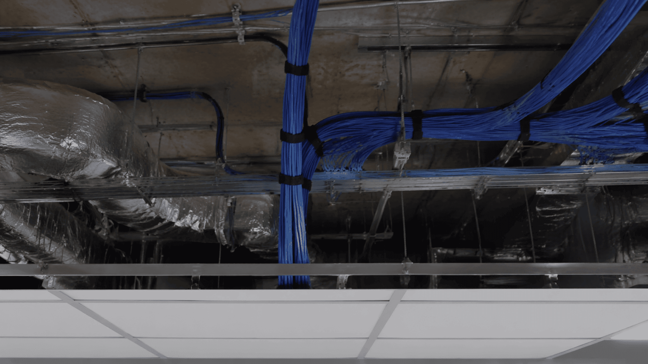 Plenum cabling installed above an office ceiling for code-compliant low voltage wiring